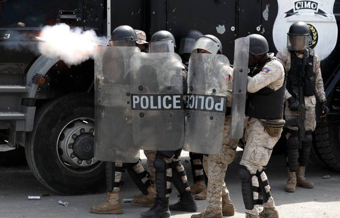 Police fire tear gas as they try to block anti government protesters from reaching United Nations headquarters, in Port au Prince, Haiti, Friday, Oct. 4, 2019.